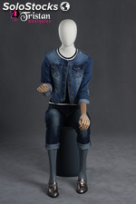 Faceless female mannequin sitting with articulable arms and hands.