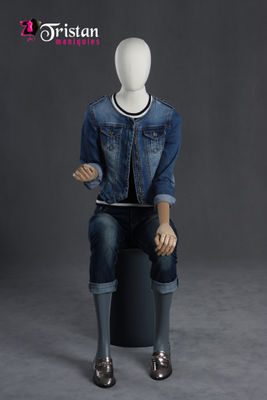 Faceless female mannequin sitting with articulable arms and hands.